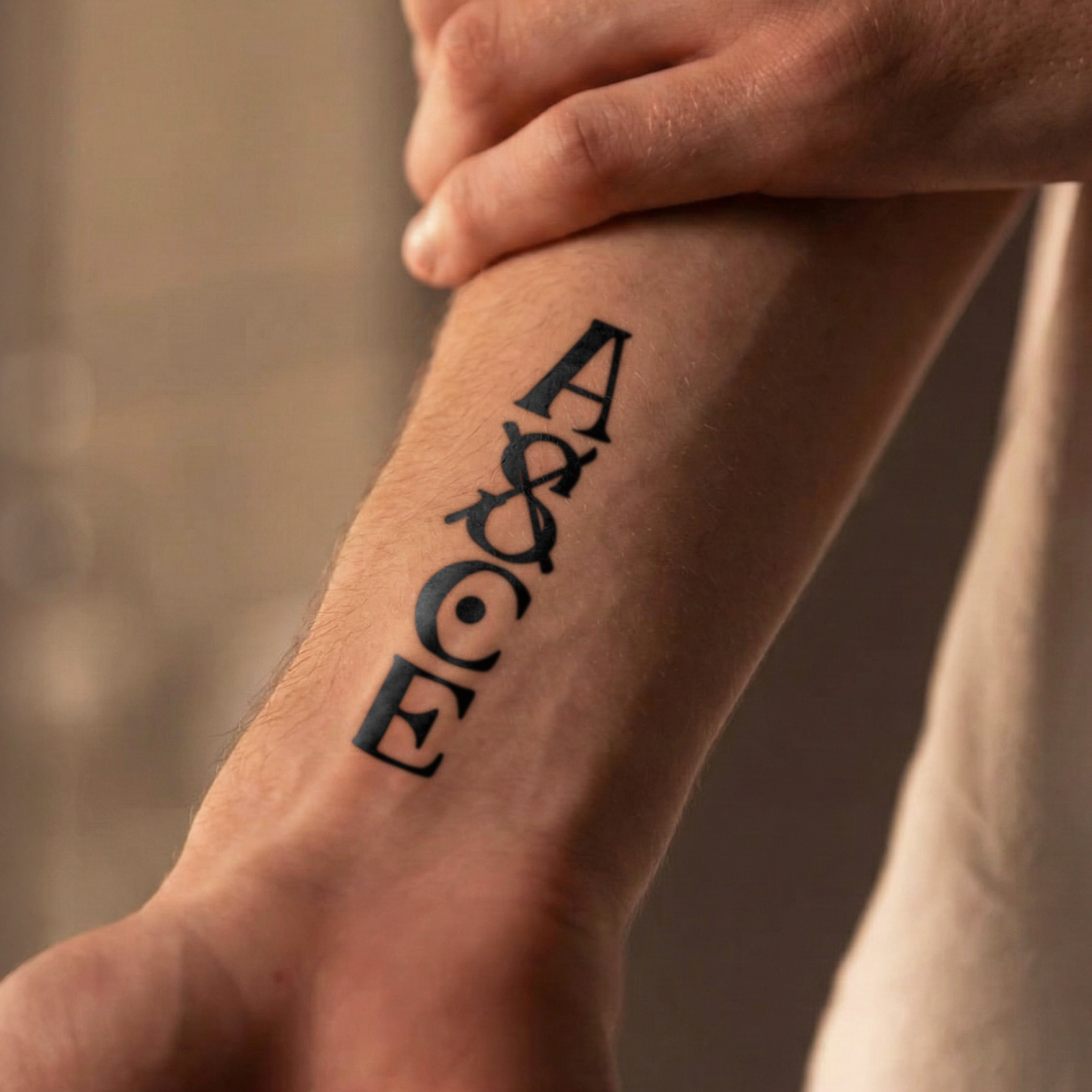 Tattoo of 'AOC' on a person's arm with a blurred background