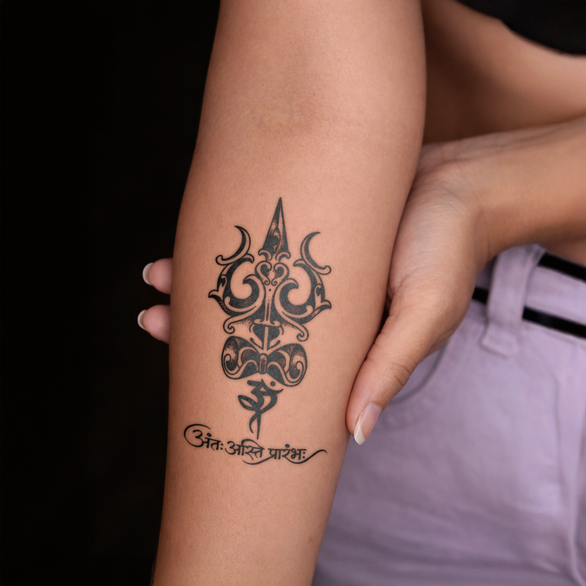 Tattoo of a symbol on a person's arm with a dark background