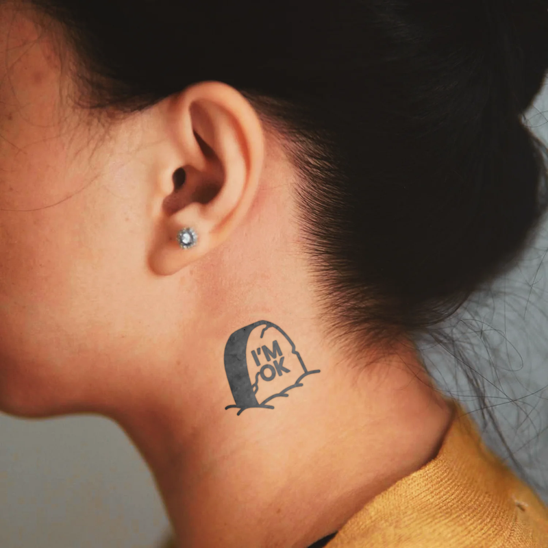 Person with a tattoo on their neck that reads 'I'm OK'.