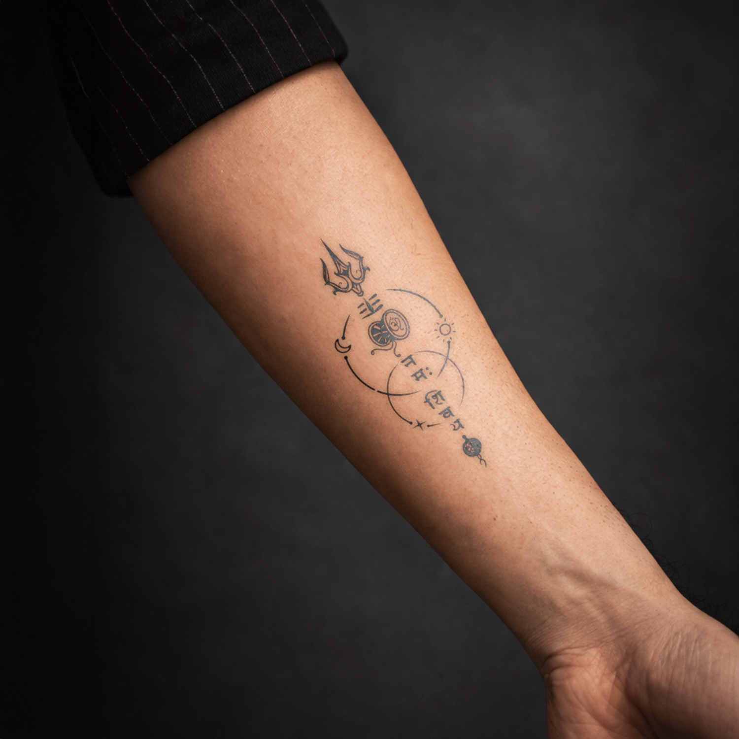Tattoo on a person's arm against a dark background