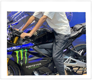 Person standing next to a Yamaha motorcycle with Monster Energy branding.