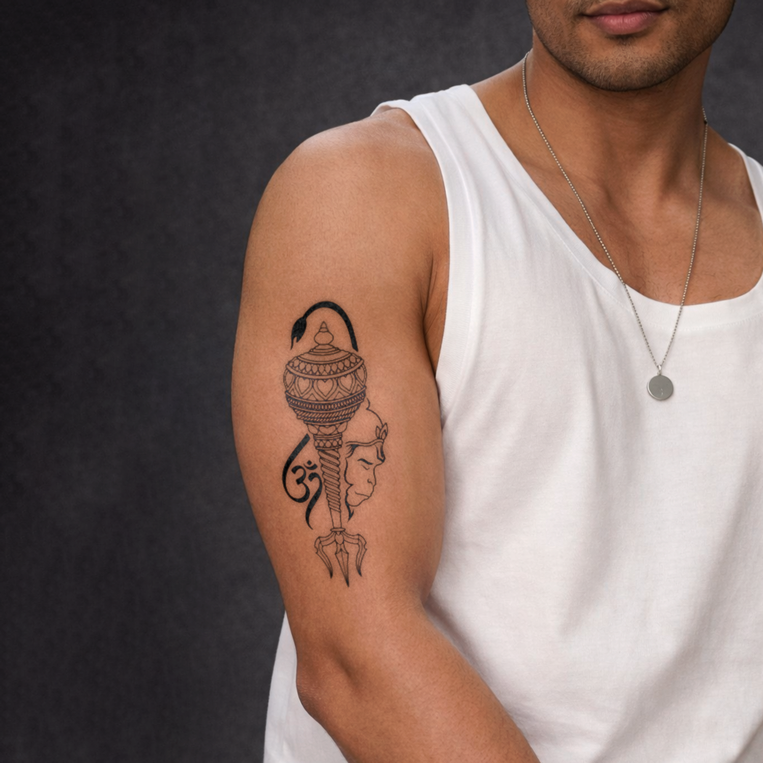 Man wearing a white tank top with a detailed tattoo on his arm against a dark background