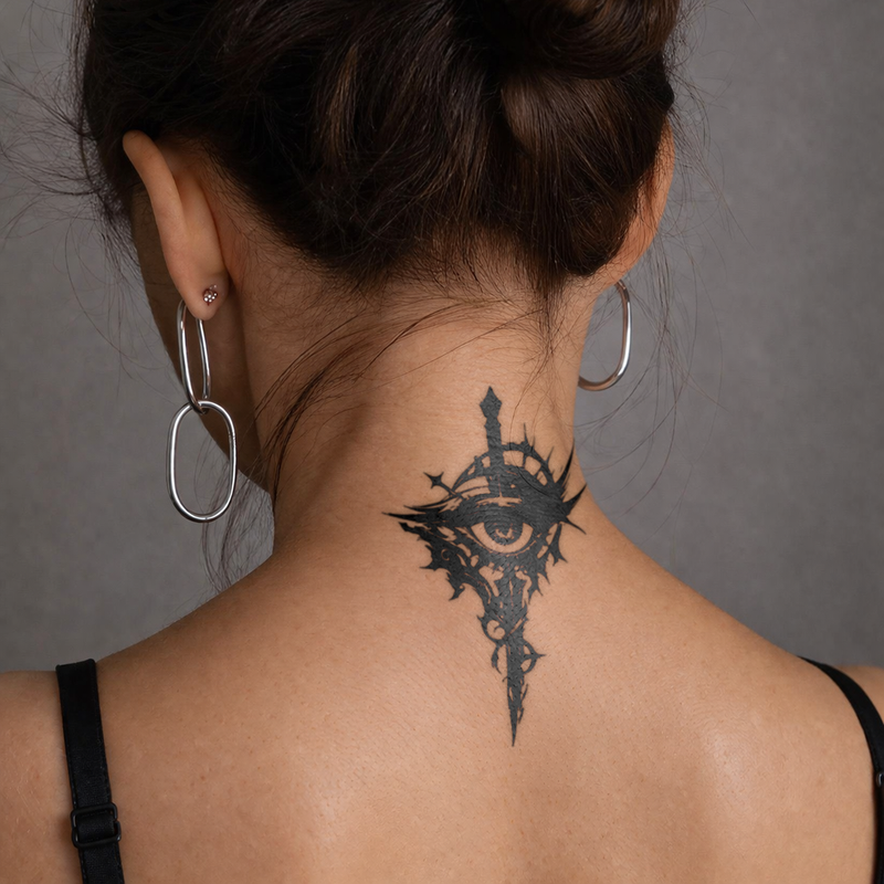 Person with a black tattoo on their neck against a gray background