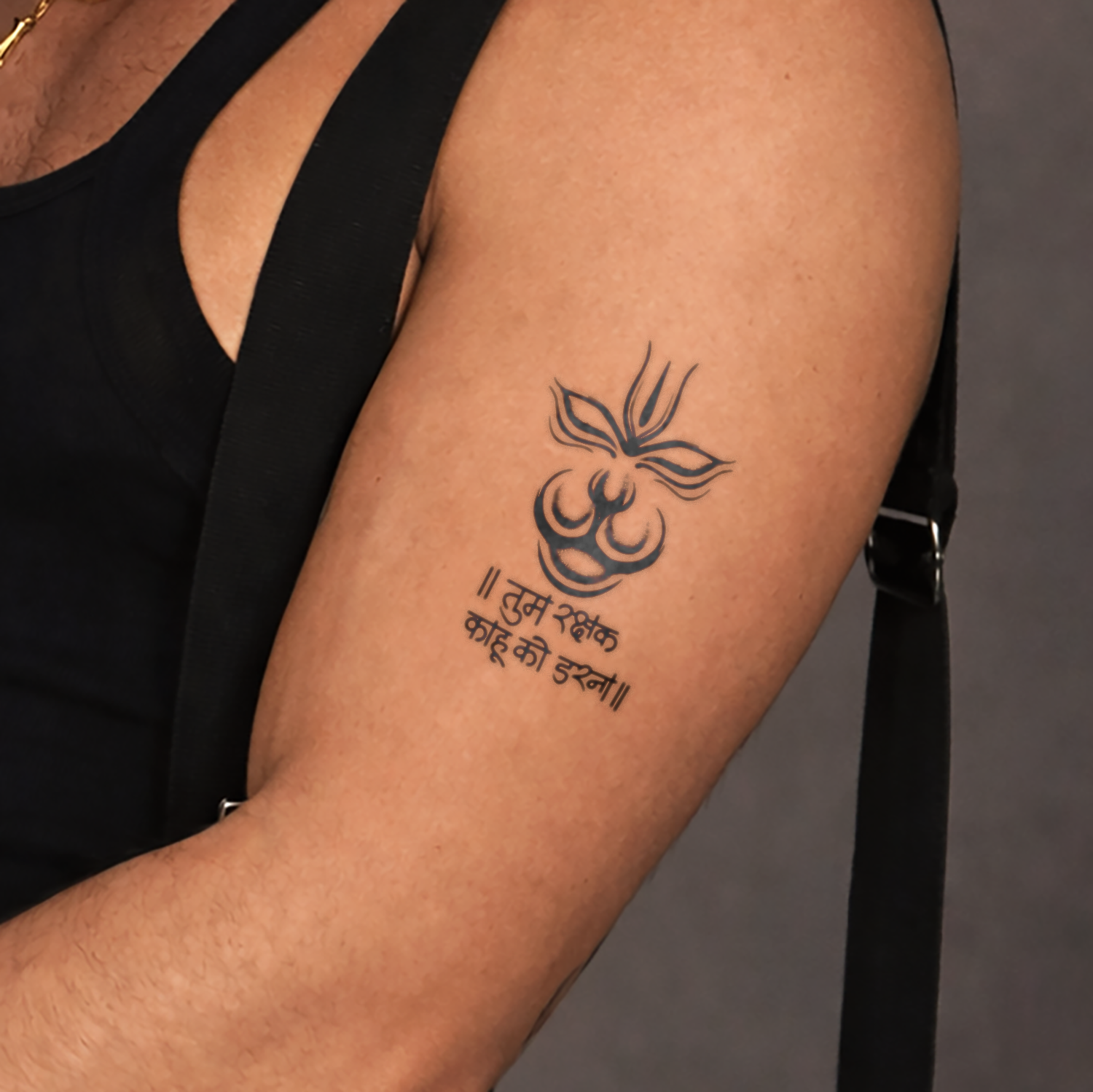 Tattoo on a person's arm with text against a neutral background