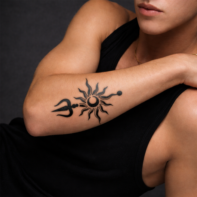 Person with a black sun and trident tattoo on their arm against a dark background