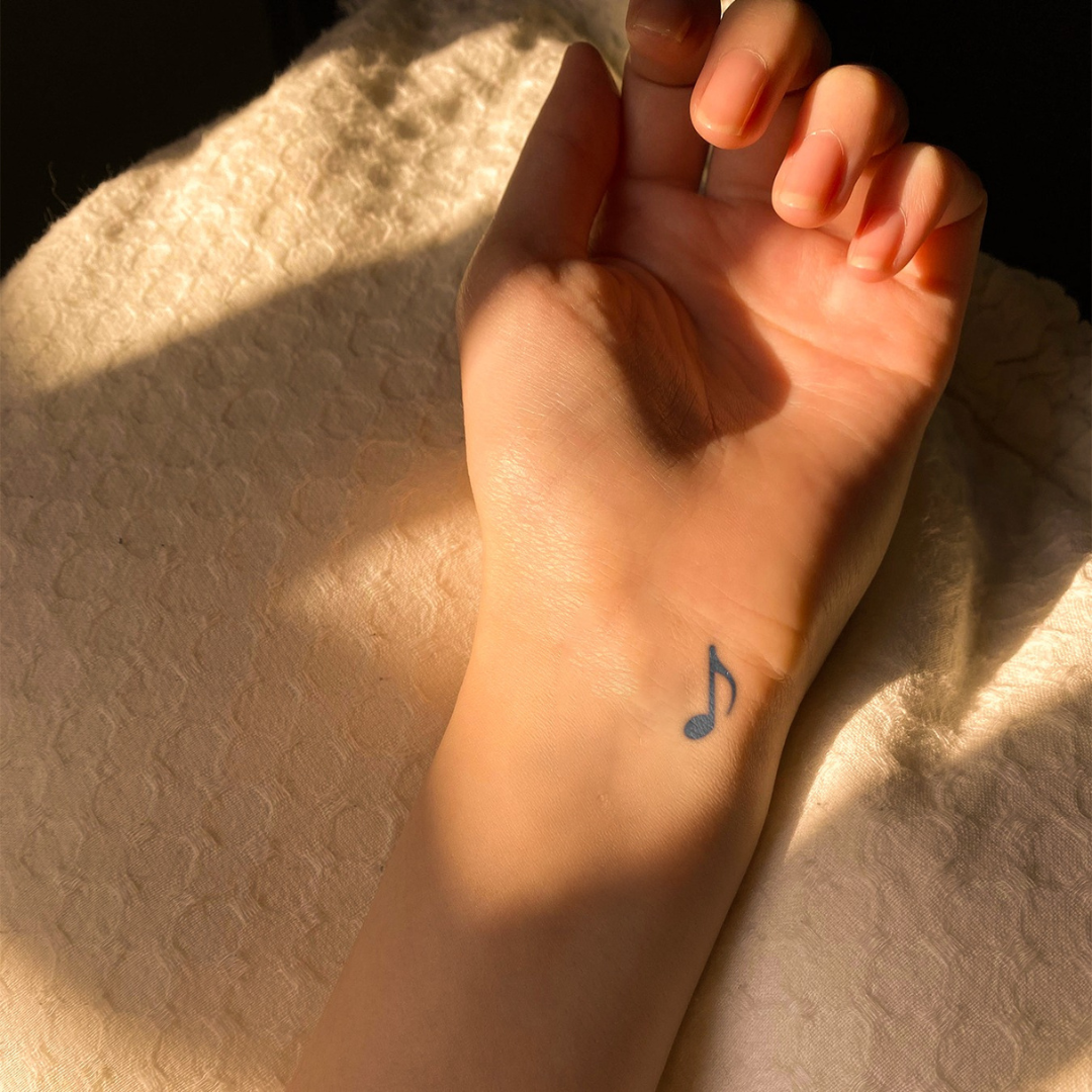 Mini Tune tattoo on wrist