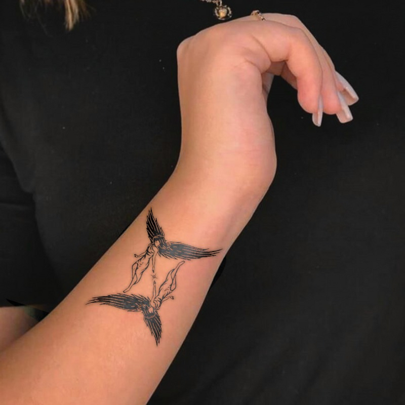 Winged Gemini Tattoo on arm