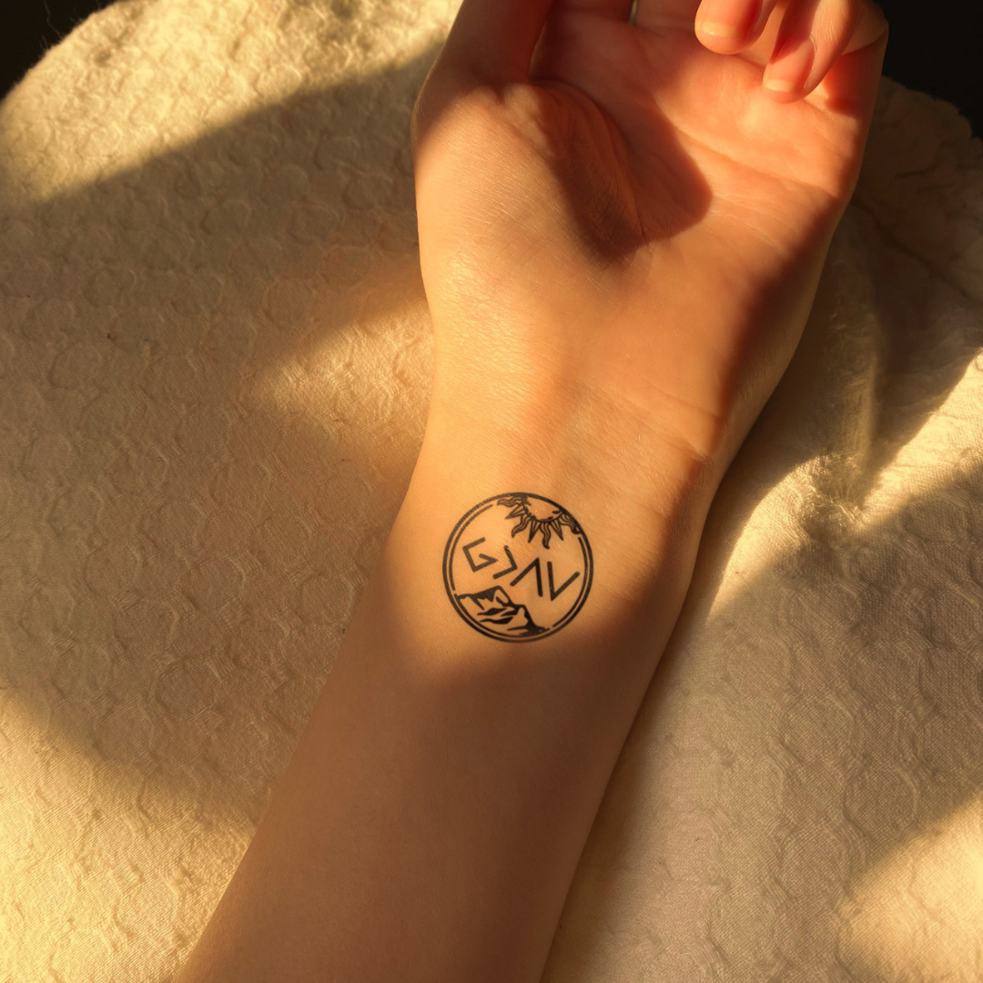 God is greater than highs and lows tattoo on hand 