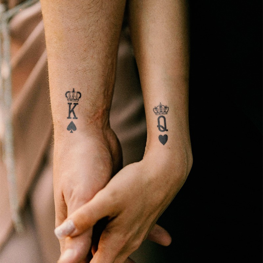 Royal pair set tattoo on a couple hand 