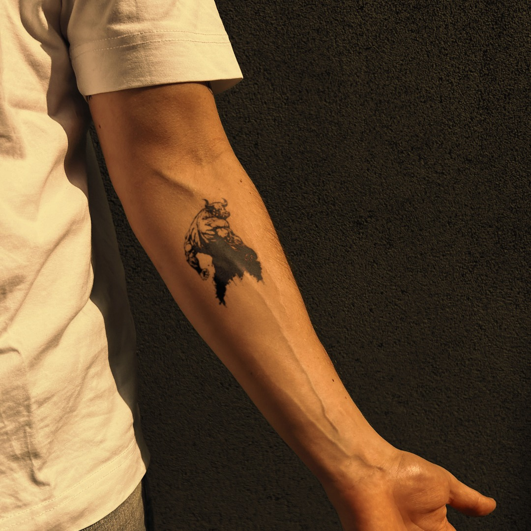 Market Maverick tattoo on arm