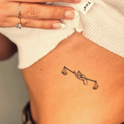 Libra's Balance Tattoo on rib 