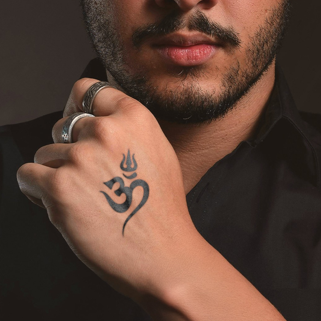 Om tattoo on back hand 