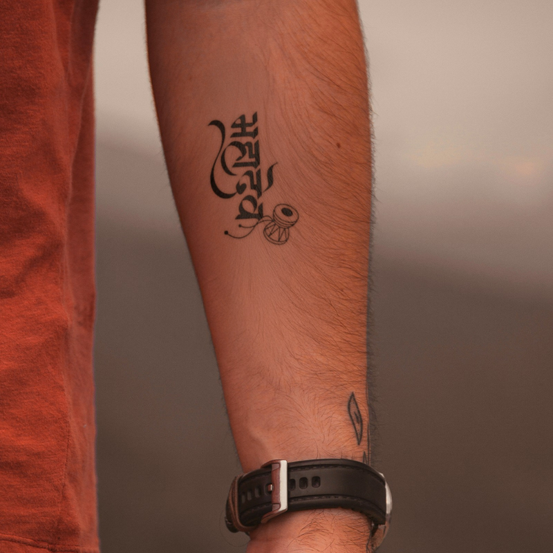 Mahadev Damru Tattoo on arm