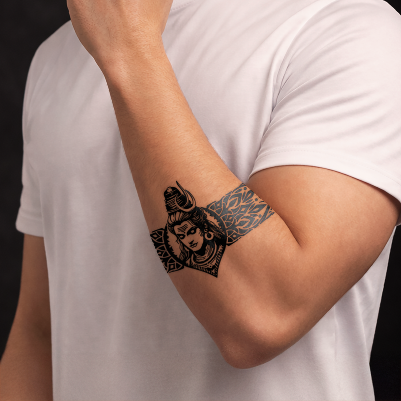 Person wearing a temporary tattoo on their arm with intricate designs.
